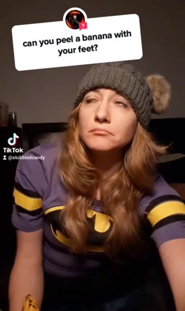 Peeling a banana with her feet